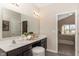 Bathroom featuring double sinks, a large mirror, and neutral color palette at 2057 Abbey Ln, Columbus, IN 47201