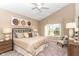 Inviting bedroom featuring a ceiling fan, a large bed, and natural light at 2057 Abbey Ln, Columbus, IN 47201
