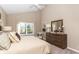 Comfortable bedroom with a large window and a wooden dresser, offering a serene and relaxing space at 2057 Abbey Ln, Columbus, IN 47201