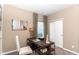 Cozy bedroom featuring a rustic desk, chair, and modern decor, illuminated by natural light from the window at 2057 Abbey Ln, Columbus, IN 47201