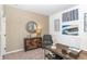 Stylish bedroom featuring neutral walls, decorative molding, and contemporary decor including a round mirror and unique accent furniture at 2057 Abbey Ln, Columbus, IN 47201