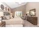 Vaulted ceiling bedroom features a large window and neutral decor at 2057 Abbey Ln, Columbus, IN 47201