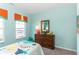 Bright and cheerful bedroom featuring a dresser with mirror, plush stuffed animal, and lots of natural light at 2057 Abbey Ln, Columbus, IN 47201