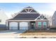Charming single-story home with a two-car garage and a well-maintained brick facade at 2057 Abbey Ln, Columbus, IN 47201