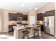 Well-lit kitchen with stainless steel appliances, granite countertops and breakfast bar seating at 2057 Abbey Ln, Columbus, IN 47201