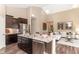Open concept kitchen with stainless steel appliances and granite island overlooking the living area at 2057 Abbey Ln, Columbus, IN 47201
