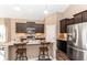 Modern kitchen with granite countertops, an island with seating, and stainless steel appliances at 2057 Abbey Ln, Columbus, IN 47201
