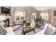 Living room area with dining table, sliding glass doors, fireplace, and hardwood floors at 2057 Abbey Ln, Columbus, IN 47201