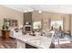 Cozy living area featuring a fireplace, kitchen, and dining space with ample natural light at 2057 Abbey Ln, Columbus, IN 47201