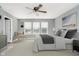 Comfortable bedroom featuring a ceiling fan, plush carpet, and a bright window for natural light at 20846 Winding Lake E Dr, Noblesville, IN 46062