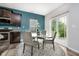 Cozy dining area showcases stylish table and chairs, complemented by a view from sliding glass doors at 20846 Winding Lake E Dr, Noblesville, IN 46062