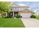 Charming two-story home with a well-manicured lawn and attached two-car garage at 20846 Winding Lake E Dr, Noblesville, IN 46062