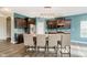 Modern kitchen with stainless steel appliances, center island and bar seating, and elegant pendant lighting at 20846 Winding Lake E Dr, Noblesville, IN 46062