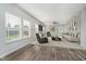 Spacious living room with hardwood floors, large windows, and comfortable seating at 20846 Winding Lake E Dr, Noblesville, IN 46062