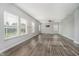 Bright and open living area with large windows and wood flooring at 20846 Winding Lake E Dr, Noblesville, IN 46062