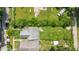 Aerial view of a home and surrounding property showcasing lawn, mature trees, a detached garage, and nearby vehicles at 2426 Lasalle St, Indianapolis, IN 46218