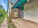 Cement back porch area, the entrance door, siding, and greenery in the back at 2426 Lasalle St, Indianapolis, IN 46218