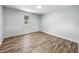 Empty bedroom features new floors and natural light from the window at 2426 Lasalle St, Indianapolis, IN 46218