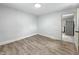 Empty bedroom features new floors and leads to the kitchen at 2426 Lasalle St, Indianapolis, IN 46218