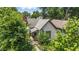 Charming home with a welcoming front porch, surrounded by lush greenery and mature trees at 2426 Lasalle St, Indianapolis, IN 46218