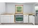 Close up of the renovated kitchen featuring an oven, white cabinets, and butcher block countertops at 2426 Lasalle St, Indianapolis, IN 46218
