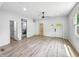 Bright living room showcasing new floors, modern fan, and views to multiple rooms in need of finishing at 2426 Lasalle St, Indianapolis, IN 46218