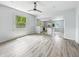 The living room with wood laminate floor and a ceiling fan overlooking a kitchen at 2426 Lasalle St, Indianapolis, IN 46218