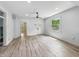 Spacious living room featuring new flooring, a ceiling fan, and natural light from a large window at 2426 Lasalle St, Indianapolis, IN 46218