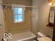 Bathroom featuring a window, bathtub, toilet and sink at 249 Ohio St, Franklin, IN 46131
