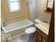 Bathroom featuring a window, bathtub, toilet and sink at 249 Ohio St, Franklin, IN 46131