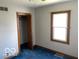 Bedroom featuring a window, closet, and blue carpeted floor at 249 Ohio St, Franklin, IN 46131