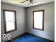 Bedroom features two windows with blue carpeted floor at 249 Ohio St, Franklin, IN 46131