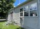 A partial side view of the home highlighting the windows, siding, and landscaping at 249 Ohio St, Franklin, IN 46131