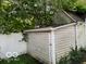 Exterior view of detached garage surrounded by mature trees and a white privacy fence at 249 Ohio St, Franklin, IN 46131
