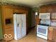Traditional kitchen with light wood cabinets, laminate countertops, and white appliances at 249 Ohio St, Franklin, IN 46131