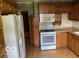 Traditional kitchen with light wood cabinets, laminate countertops, and white appliances at 249 Ohio St, Franklin, IN 46131
