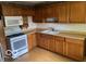 Traditional kitchen with light wood cabinets, laminate countertops, and white appliances at 249 Ohio St, Franklin, IN 46131