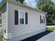 Side exterior view of the home showcasing windows and vinyl siding at 249 Ohio St, Franklin, IN 46131