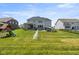 A large backyard boasts a well-kept lawn and patio, providing ample space for recreation and relaxation at 2566 Maple Creek Dr, Westfield, IN 46074