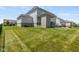 A spacious backyard features a well-maintained lawn and a large patio, perfect for outdoor enjoyment and entertaining at 2566 Maple Creek Dr, Westfield, IN 46074