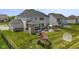 An elevated perspective reveals a backyard with a patio and playset, showcasing the ideal setting for Gathering enjoyment at 2566 Maple Creek Dr, Westfield, IN 46074