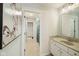 Bright bathroom with a marble countertop vanity, and view of the hallway and shower at 2566 Maple Creek Dr, Westfield, IN 46074