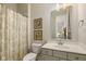 Bright bathroom featuring a shower/tub combination, vanity, framed mirror and floral artwork at 2566 Maple Creek Dr, Westfield, IN 46074