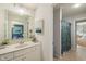 Bright bathroom with vanity, marble countertop, and view to an adjacent bedroom and bath at 2566 Maple Creek Dr, Westfield, IN 46074