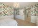 This stylish bedroom is designed with colorful floral wallpaper and neutral carpet at 2566 Maple Creek Dr, Westfield, IN 46074