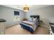 Cozy bedroom with blue accents, carpet flooring, and ample natural light from the window at 2566 Maple Creek Dr, Westfield, IN 46074