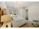 Bedroom features a chandelier, neutral colors, and large windows for bright and airy living at 2566 Maple Creek Dr, Westfield, IN 46074