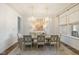 Elegant dining room featuring two crystal chandeliers, modern decor, and plenty of seating at 2566 Maple Creek Dr, Westfield, IN 46074