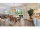 Open dining room features a wooden table, sliding glass doors to the patio, and elegant decor at 2566 Maple Creek Dr, Westfield, IN 46074