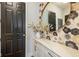 An entryway featuring floral wallpaper and a round mirror above a countertop at 2566 Maple Creek Dr, Westfield, IN 46074